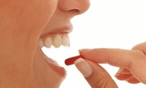 woman-eating-pill[1]